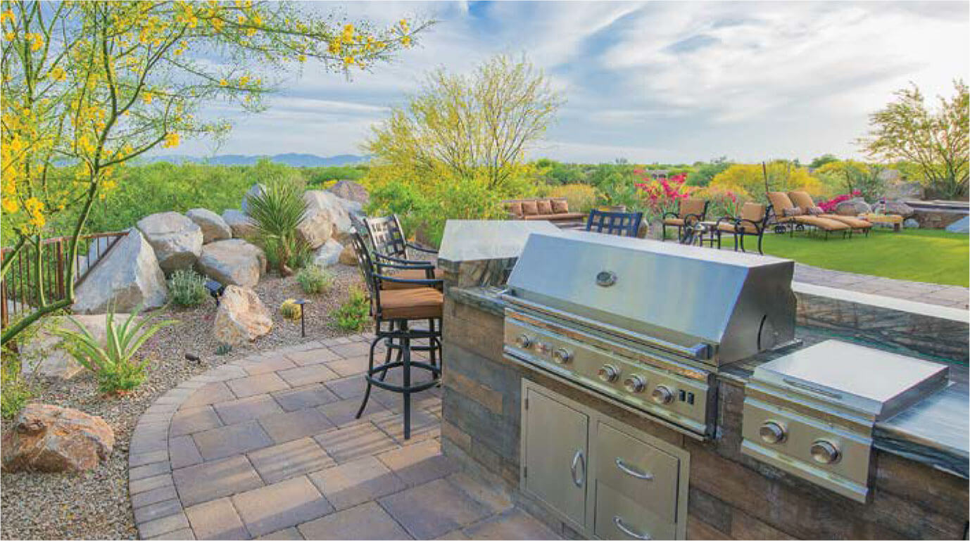 Landscaped backyard with grill